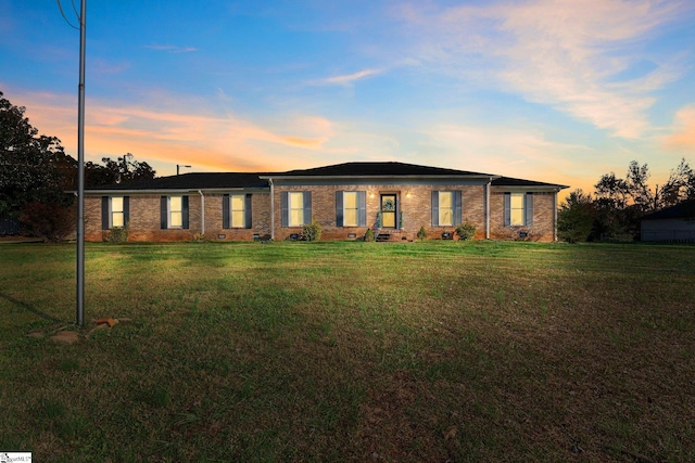 ranch-style house with a yard