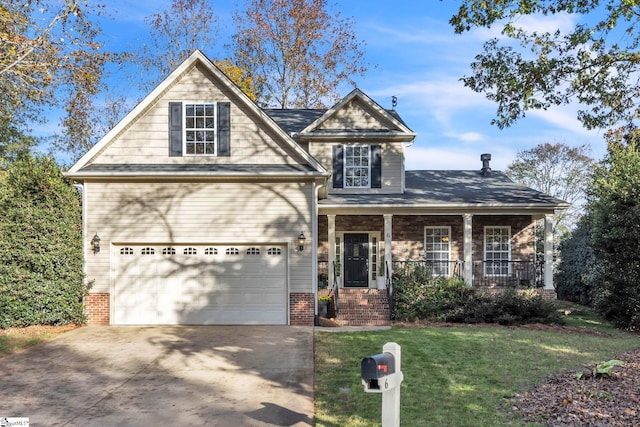 view of front of property featuring a front yard, a porch, and a garage