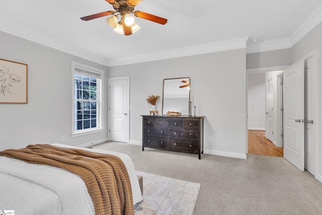 carpeted bedroom featuring ceiling fan and ornamental molding