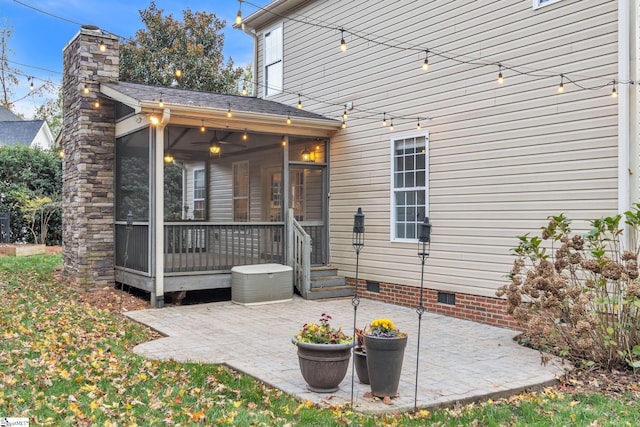 rear view of house with a patio area and a sunroom