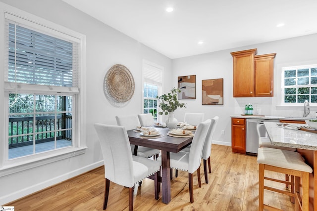 dining room with light hardwood / wood-style floors and sink