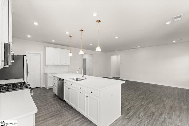 kitchen featuring white cabinetry, sink, pendant lighting, a center island with sink, and appliances with stainless steel finishes