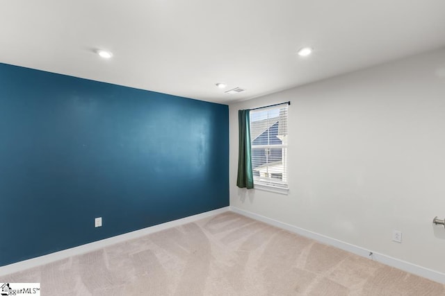 spare room with light colored carpet