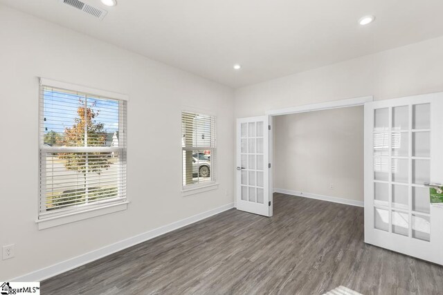 unfurnished room featuring french doors and dark hardwood / wood-style floors