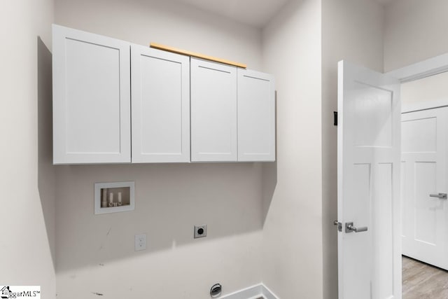 laundry area featuring cabinets, hookup for a washing machine, light wood-type flooring, and hookup for an electric dryer