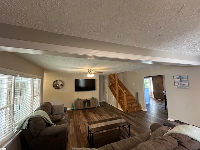 living room featuring ceiling fan, dark hardwood / wood-style flooring, and a textured ceiling