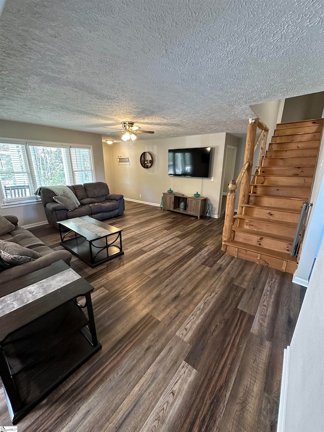 living room featuring a textured ceiling, dark hardwood / wood-style flooring, and ceiling fan