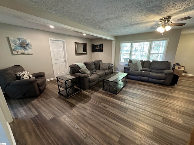 living room featuring a textured ceiling, dark hardwood / wood-style floors, and ceiling fan