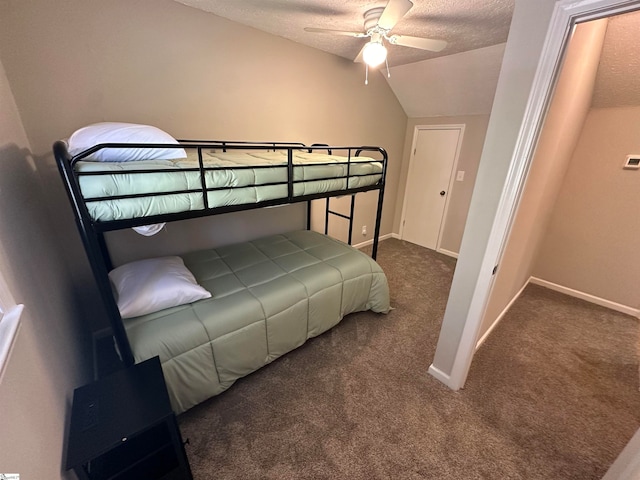 bedroom with dark colored carpet, ceiling fan, a textured ceiling, and vaulted ceiling