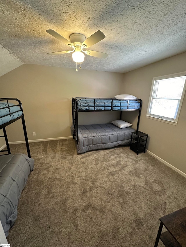 carpeted bedroom featuring ceiling fan, a textured ceiling, and vaulted ceiling