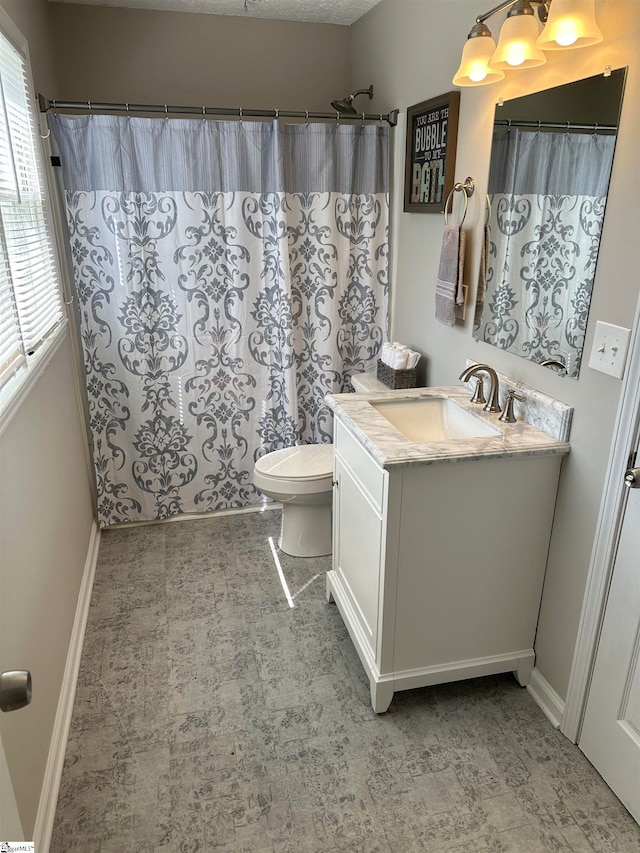 bathroom with vanity, a shower with shower curtain, and toilet