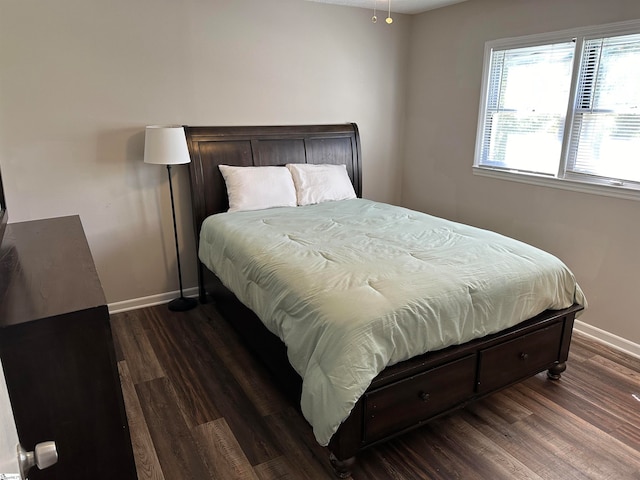 bedroom with dark hardwood / wood-style flooring