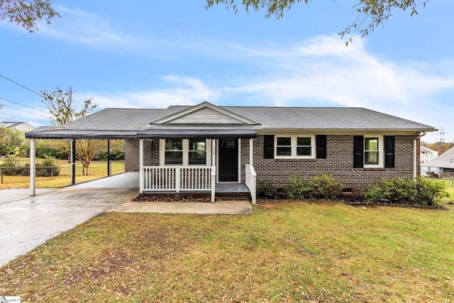 single story home with covered porch, a carport, and a front yard