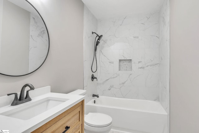 full bathroom with toilet, vanity, and tiled shower / bath