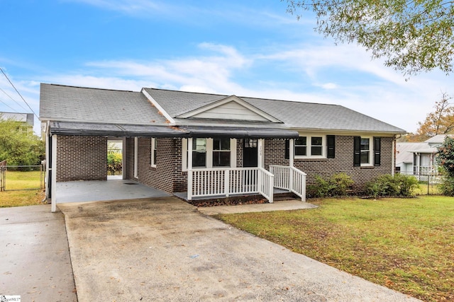 single story home featuring a front lawn and a carport