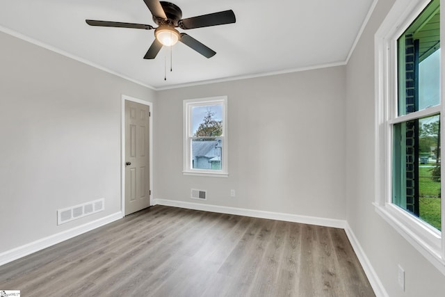 unfurnished room featuring crown molding, ceiling fan, and light wood-type flooring