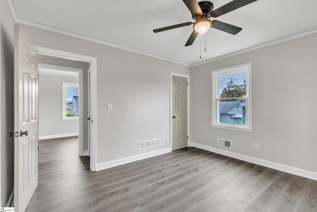 unfurnished room featuring ceiling fan, wood-type flooring, and ornamental molding