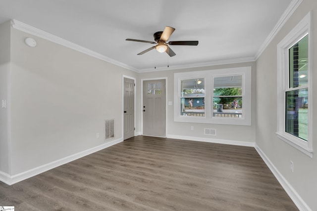 spare room featuring dark hardwood / wood-style flooring, ceiling fan, and ornamental molding