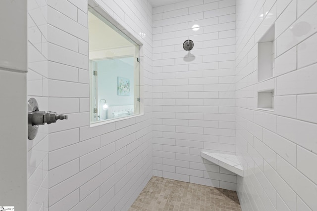 bathroom with a tile shower