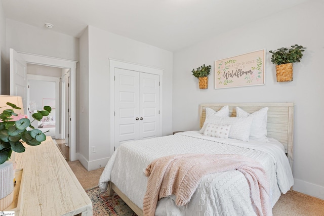 bedroom with light carpet and a closet