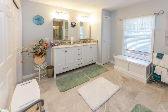 bathroom with a textured ceiling and vanity