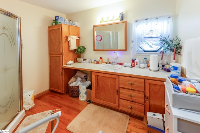 bathroom with vanity, hardwood / wood-style flooring, and an enclosed shower