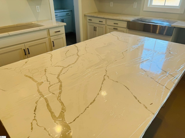 kitchen featuring light stone counters and black electric cooktop