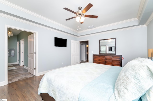 bedroom featuring ceiling fan, dark hardwood / wood-style flooring, and ornamental molding