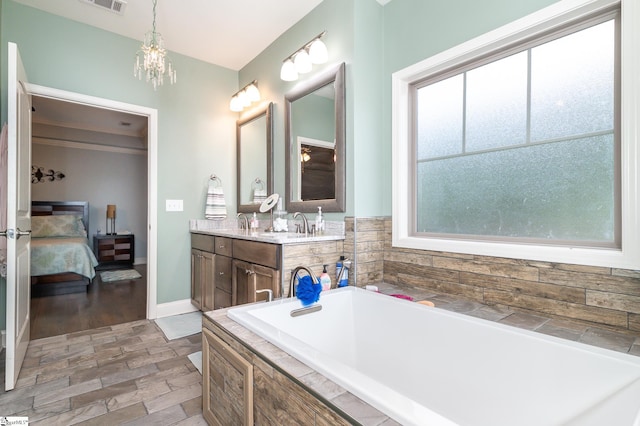 bathroom with hardwood / wood-style floors, vanity, and a bathtub