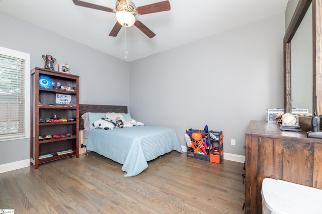 bedroom featuring ceiling fan and dark hardwood / wood-style flooring