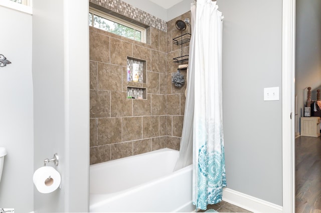 bathroom featuring shower / tub combo with curtain and hardwood / wood-style floors