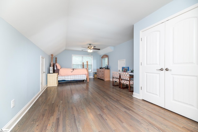 bedroom with ceiling fan, dark hardwood / wood-style flooring, and lofted ceiling