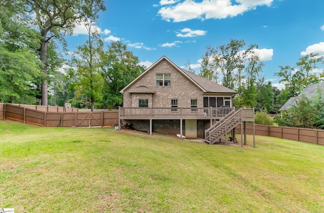 rear view of property featuring a wooden deck and a yard