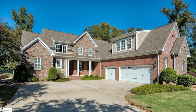 view of front of house featuring a front lawn, covered porch, and a garage