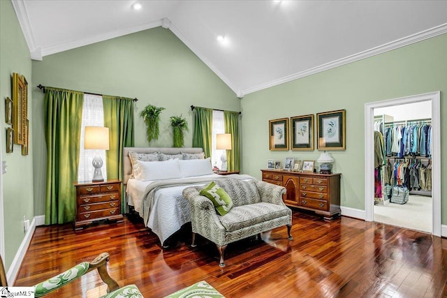 bedroom featuring ornamental molding, high vaulted ceiling, a spacious closet, dark hardwood / wood-style floors, and a closet