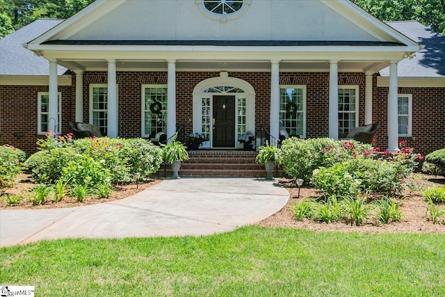 entrance to property featuring a porch