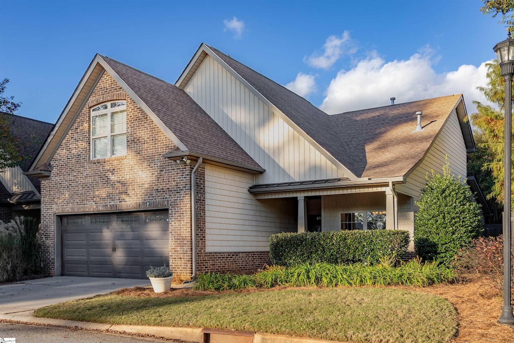 front facade with a garage and a front lawn