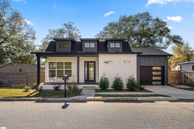 view of front of property featuring covered porch and a garage