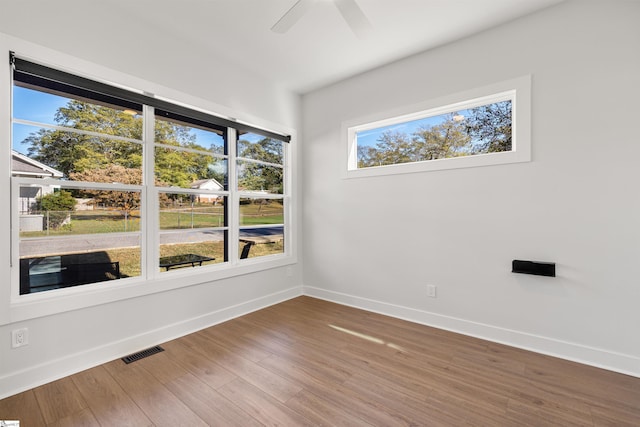 unfurnished room with hardwood / wood-style floors and ceiling fan