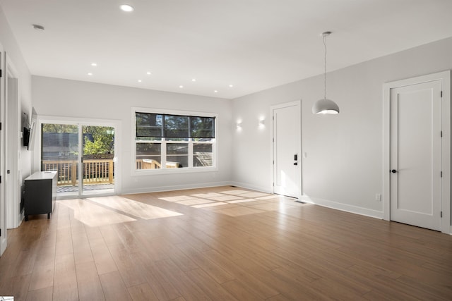 unfurnished living room with hardwood / wood-style floors