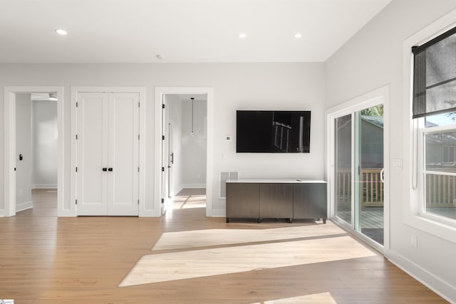 unfurnished living room with light hardwood / wood-style flooring