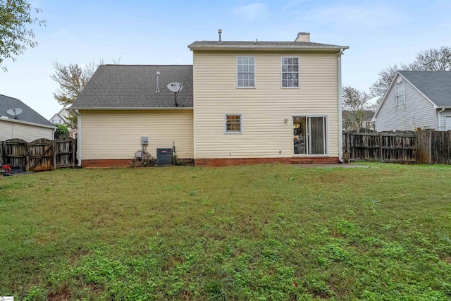 back of property featuring a yard and cooling unit