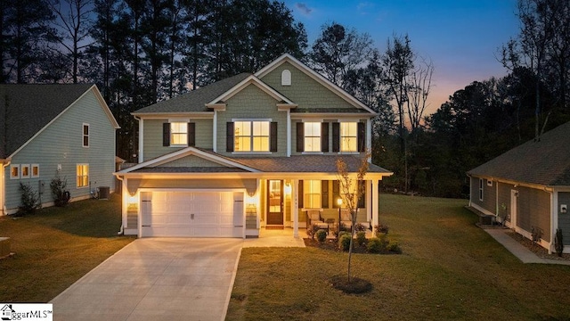 craftsman-style home with a lawn, central AC unit, and a garage