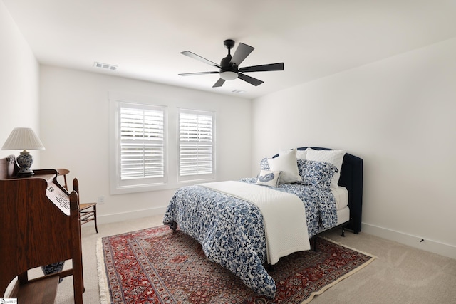 bedroom with ceiling fan and light carpet