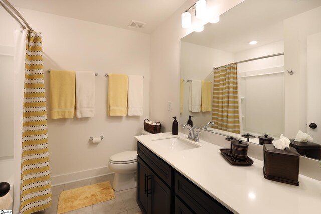 bathroom with tile patterned flooring, vanity, curtained shower, and toilet