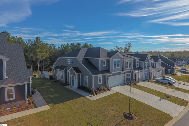 view of front of house featuring a garage and a front lawn