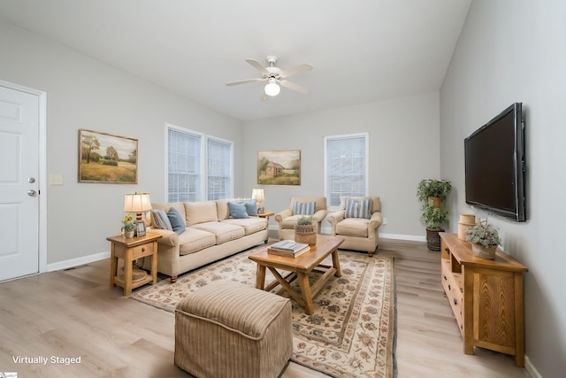 living room featuring light hardwood / wood-style flooring and ceiling fan