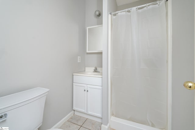 bathroom featuring curtained shower, tile patterned flooring, vanity, and toilet