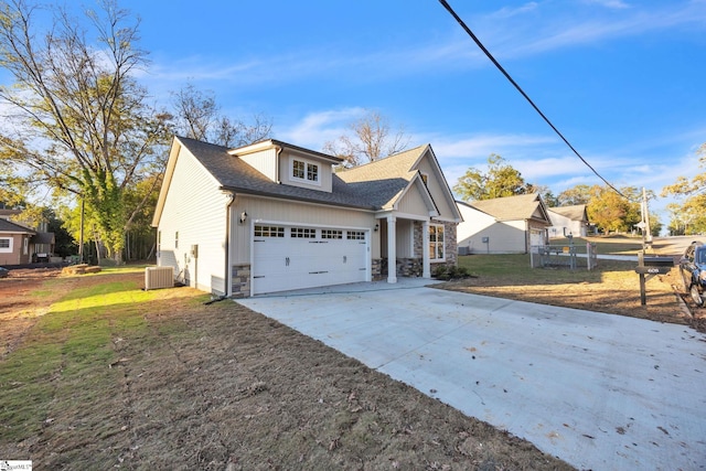 view of side of home with a yard, central AC, and a garage