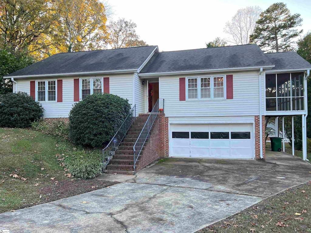 view of front facade featuring a sunroom and a garage